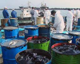 Workers tackle oil spill at stranded N. Korean ship